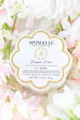 Spongellé product with 'Fresia Pear' flavor surrounded by white and pink flowers