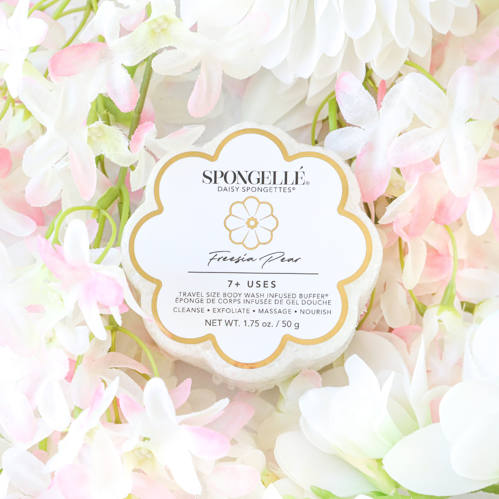 Spongellé product with 'Fresia Pear' flavor surrounded by white and pink flowers