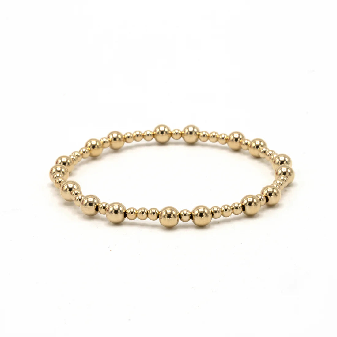 Gold beaded bracelet on a white background