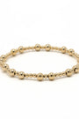 Gold beaded bracelet on a white background