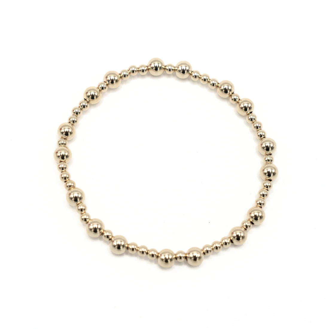 Gold beaded bracelet on a white background