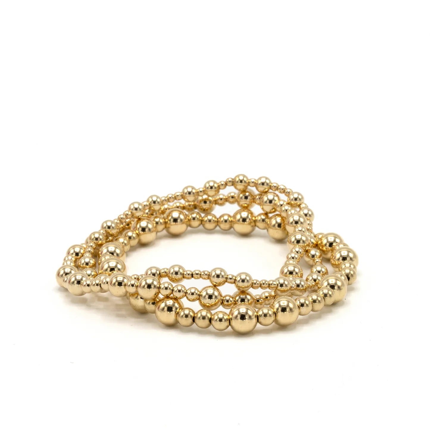 Gold beaded bracelet on a white background
