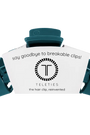 A dark teal hair clip with a white paper insert card that reads 'say goodbye to breakable clips! TELETIES the hair clip, reinvented' on a plain white background.
