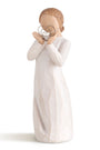Decorative figurine of a woman holding a heart-shaped object on a white background