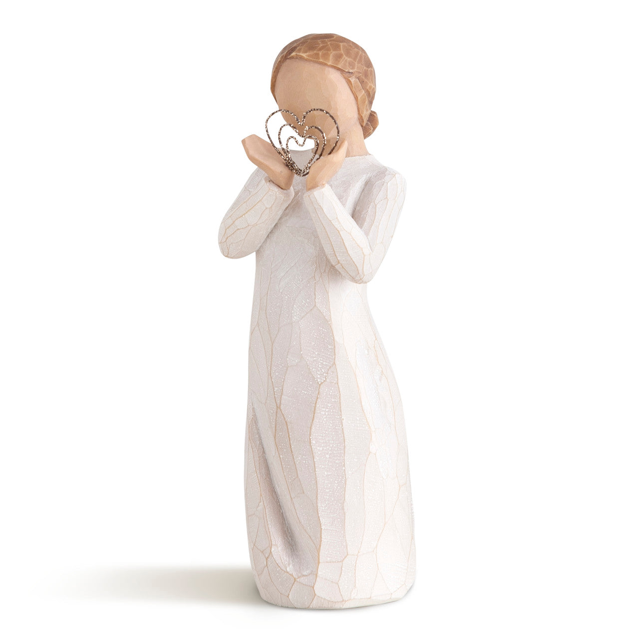 Decorative figurine of a woman holding a heart-shaped object on a white background