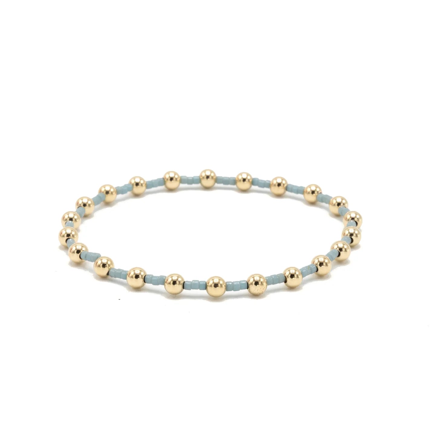 Bracelet with gold beads on a white background