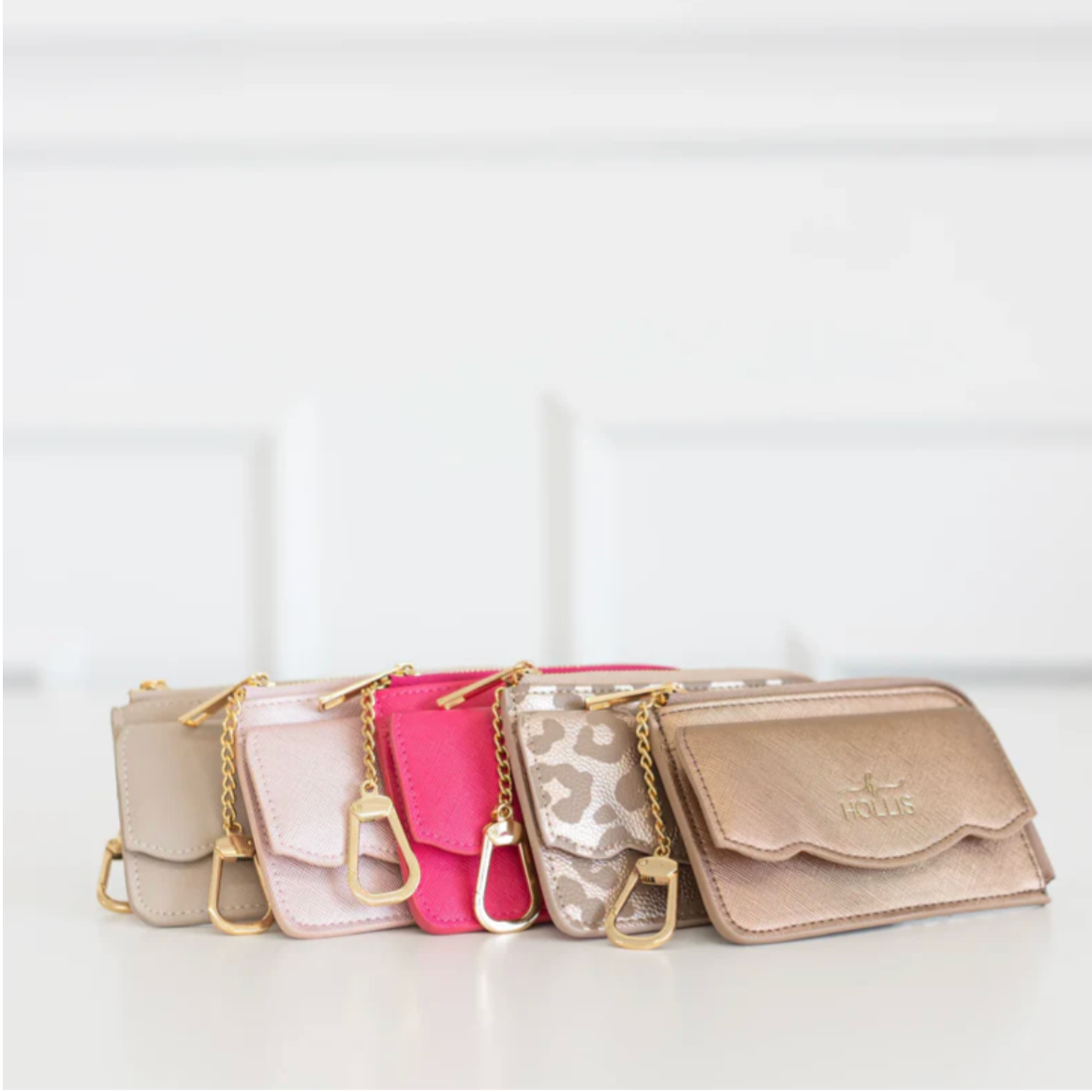 Set of five handbags in various colors on a white background