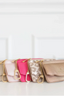 Set of five handbags in various colors on a white background