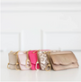 Set of five handbags in various colors on a white background