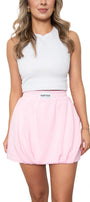 Woman wearing a white sleeveless top and pink skirt with a brand logo on a white background