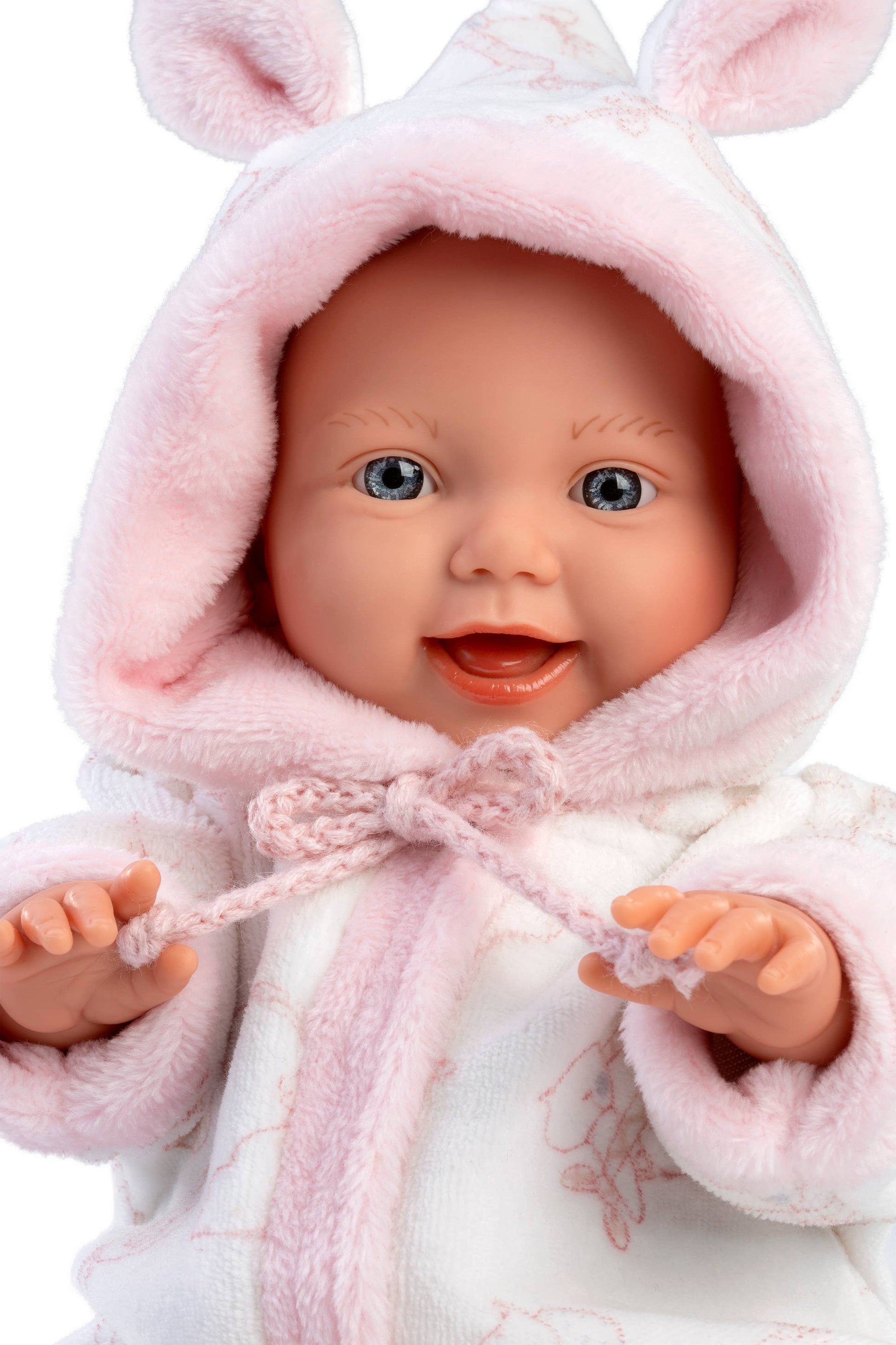 Baby doll in a pink bunny outfit with a white background
