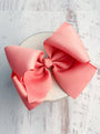 Large pink bow on a white background