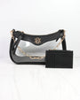 Black handbag with gold chain and matching black wallet on a white background