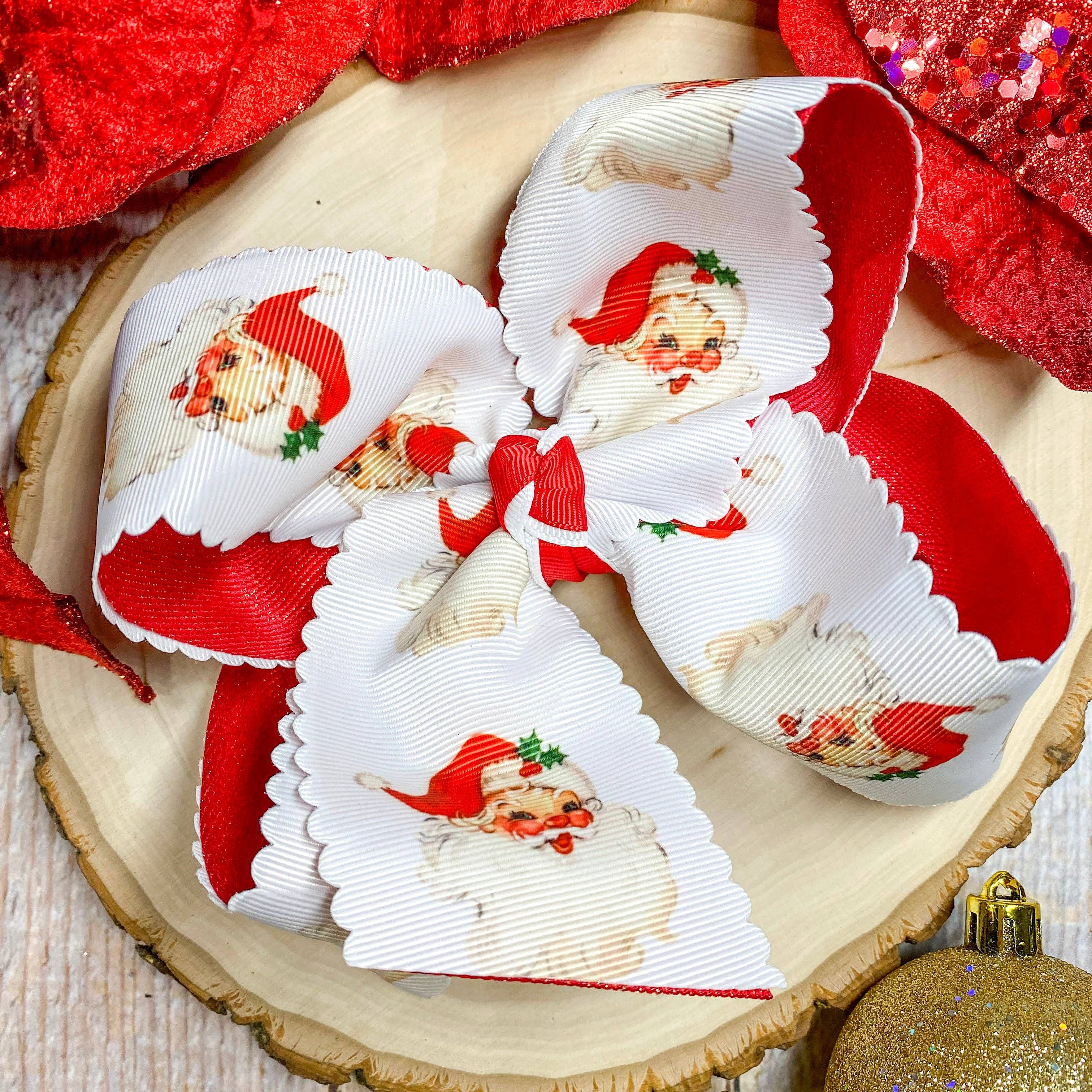 Decorative bow with Santa Claus design on a wooden surface with Christmas ornaments.