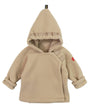 Beige baby hoodie with backpack straps on a white background