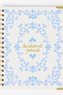 Devotional journal with blue floral design and gold text on a white background