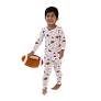 A toddler wearing a white long-sleeve pajama set with a colorful cartoon pattern, holding a small football against a plain white background.