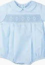 Light blue blouse with embroidery details on a plain background