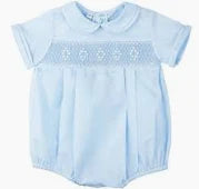 Light blue blouse with embroidery details on a plain background
