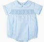 Light blue blouse with embroidery details on a plain background