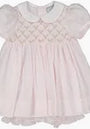 Pink baby dress with lace details on a white background