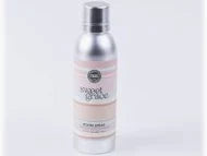 Silver spray bottle with a label on a white background