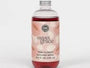 Bottle of Sweet Grace pink flower body wash with a floral design on the label.