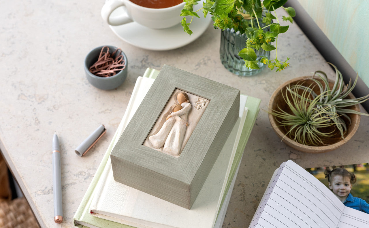 Decorative box with a Mother and daughter figure on a desk with stationery items