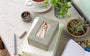 Decorative box with a Mother and daughter figure on a desk with stationery items