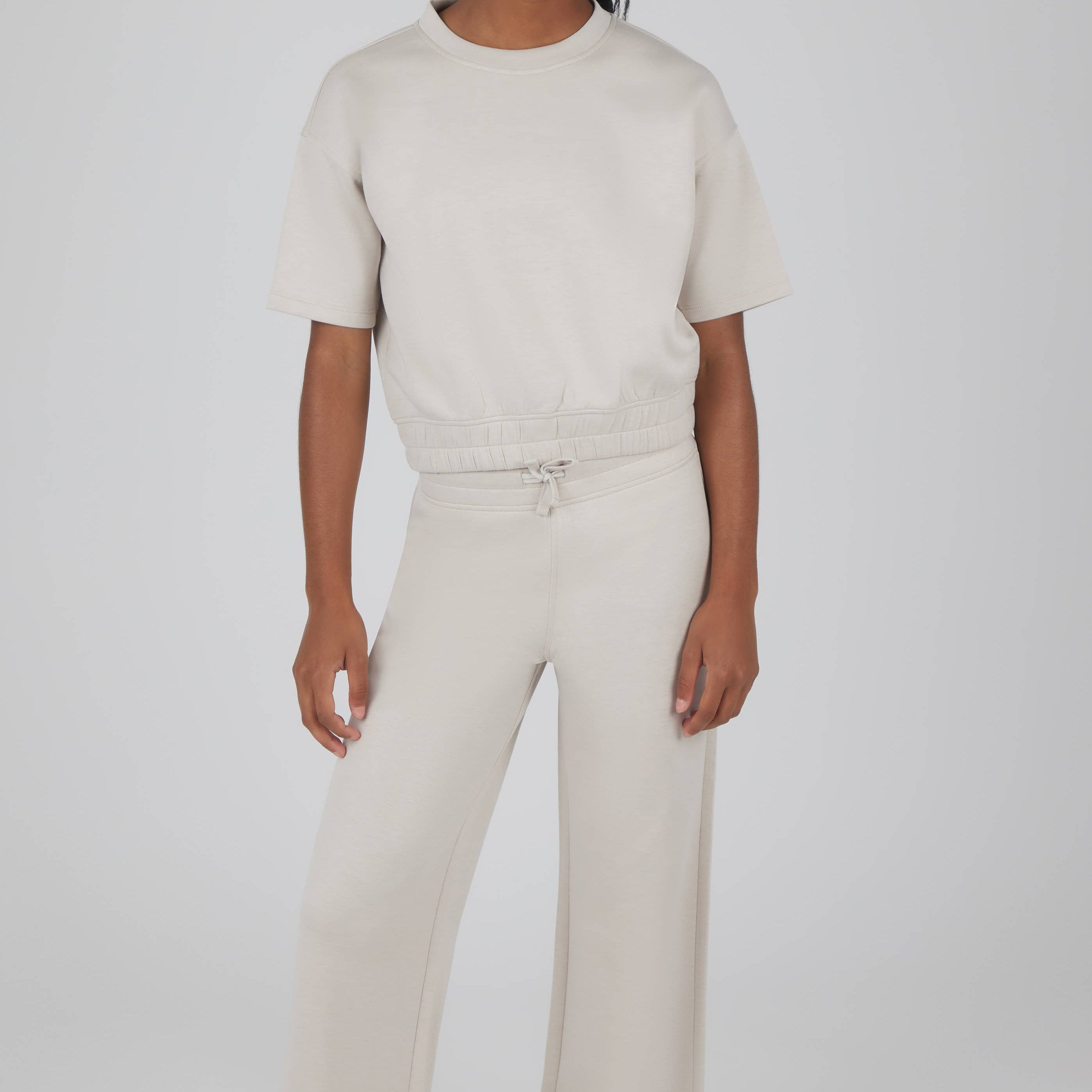 Person wearing a two-piece outfit on a white background