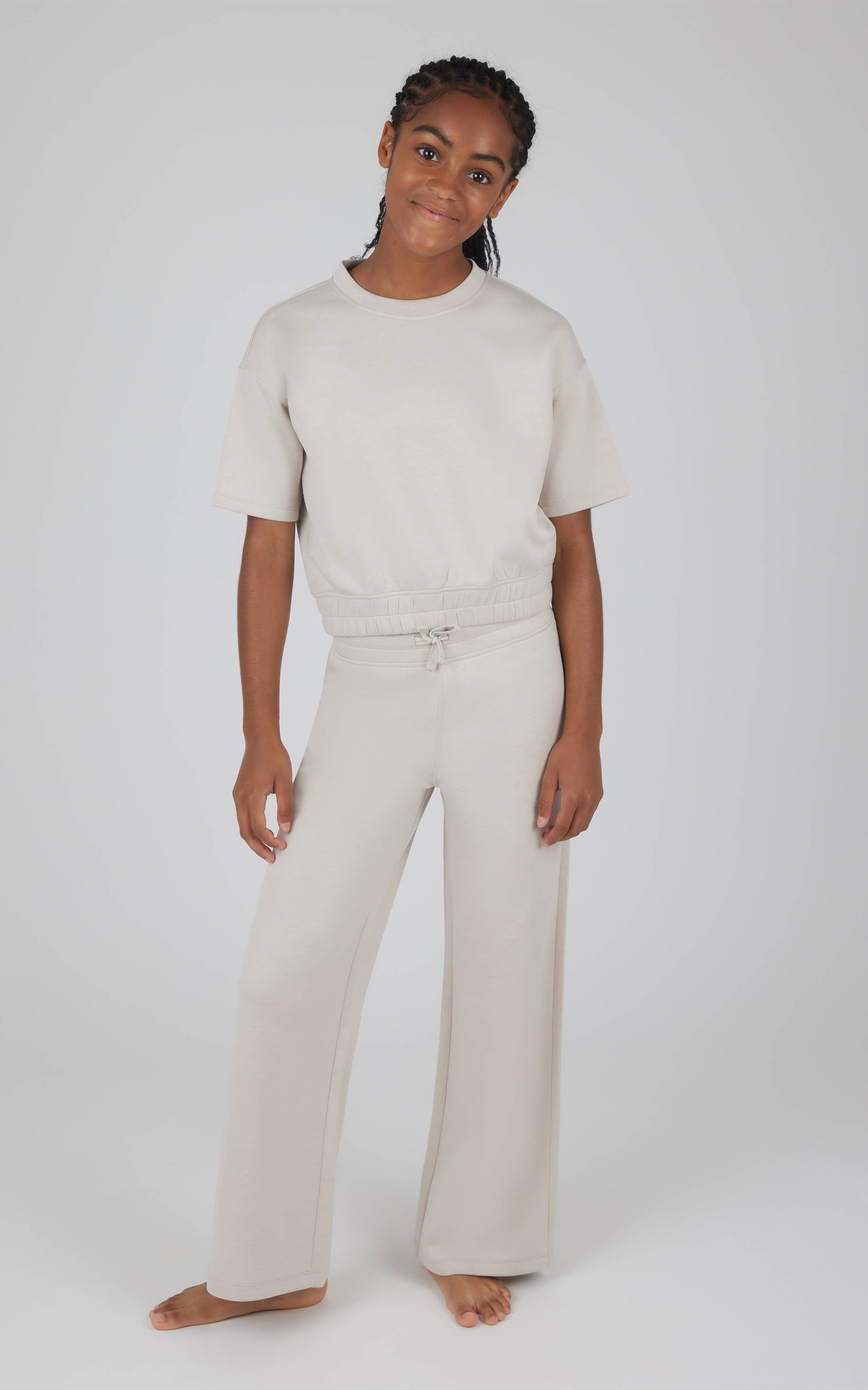 Person wearing a two-piece outfit on a white background