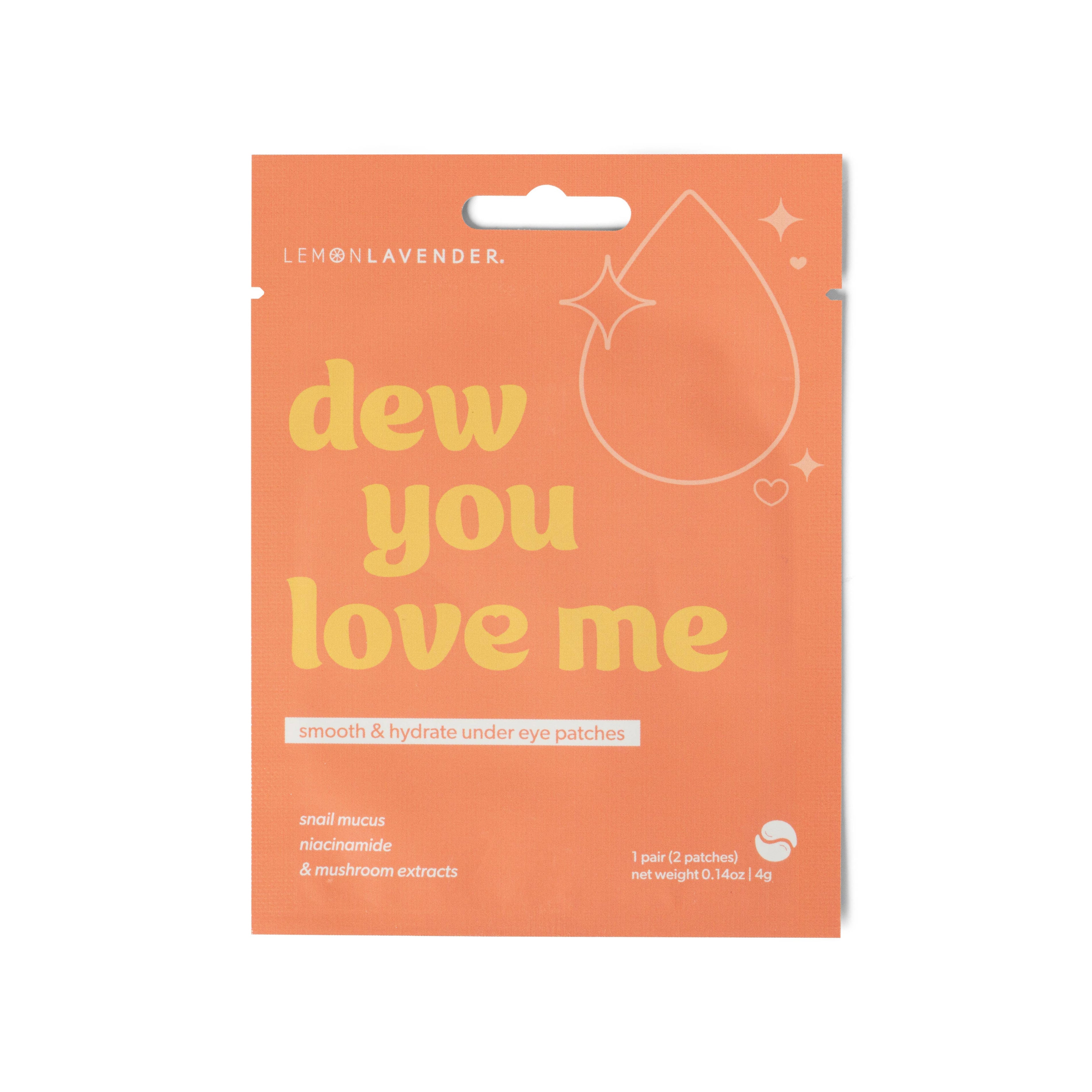 Orange packaging of 'dew you love me' eye patches with lemon lavender branding.