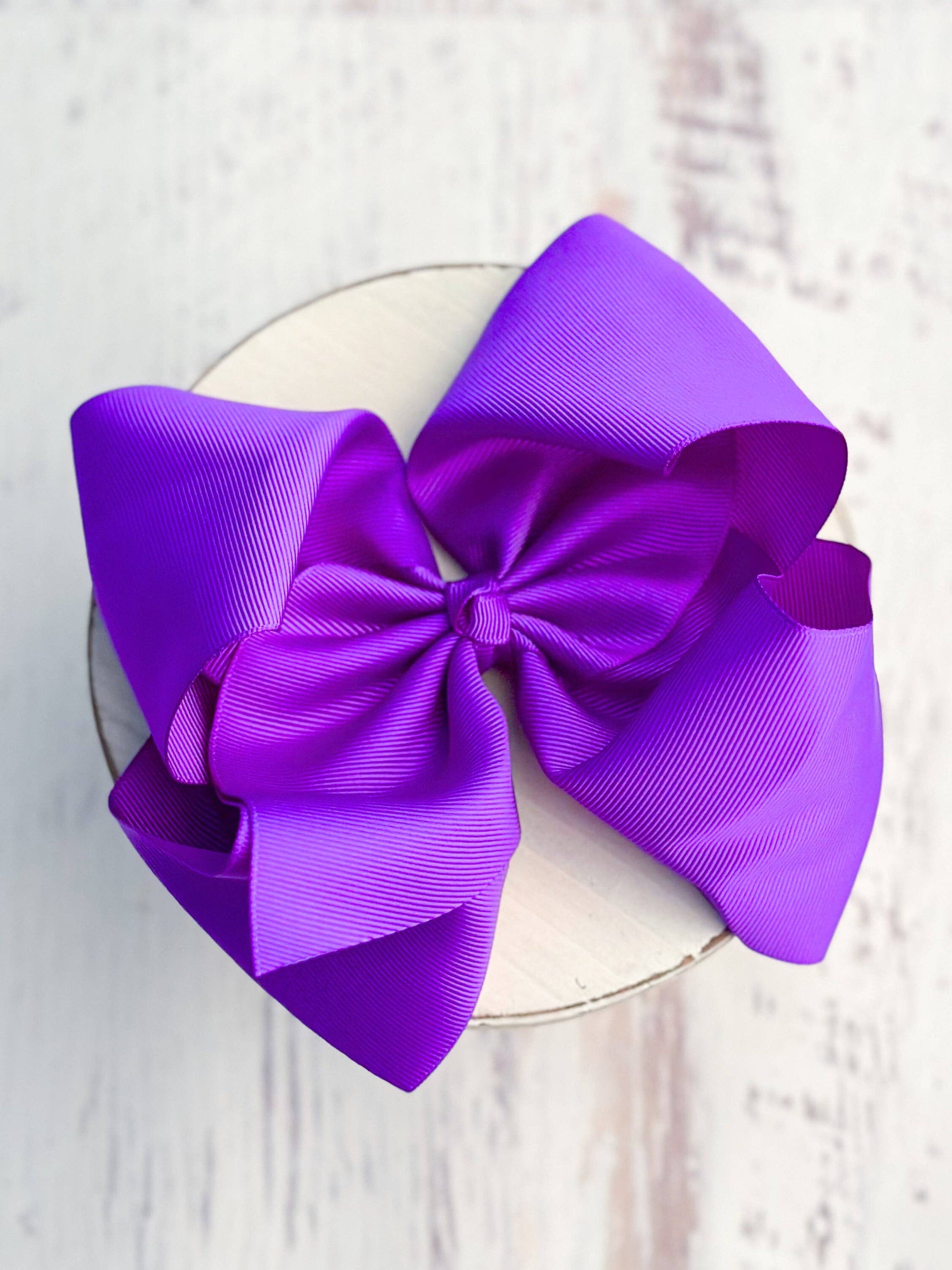 Large purple bow on a white background
