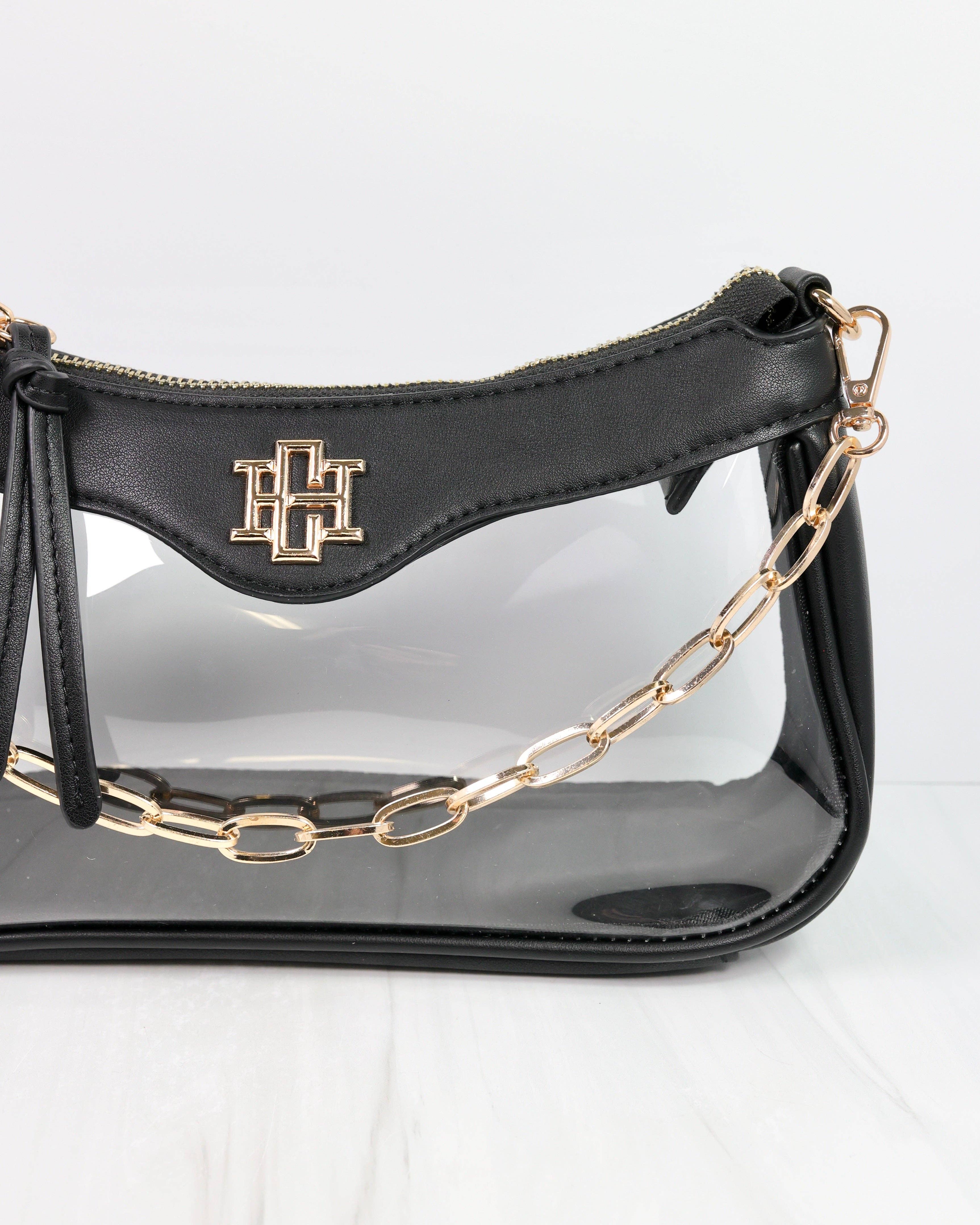Black handbag with gold chain strap on a white background
