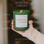 Green candle labeled 'Christmas Cookies' held by a hand with product details overlay.