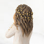 Statue of a woman with braided hair and gold beads on a white background