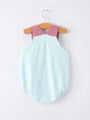 Baby romper with red checkered top and blue striped bottom on a hanger against a white background