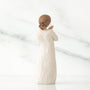 White ceramic figurine with textured surface on a white background