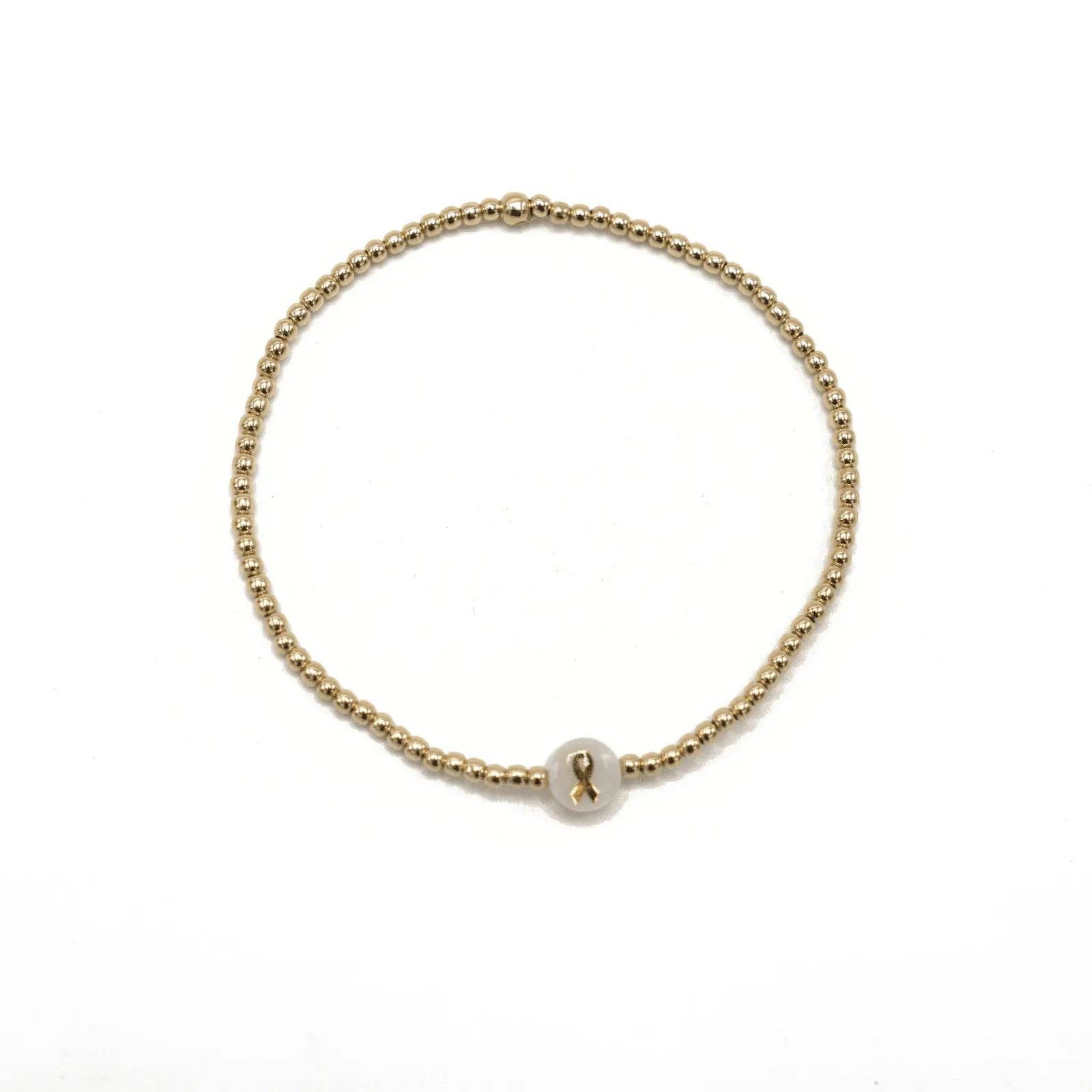 Gold bracelet with a pearl charm on a white background
