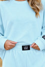 Ice blue waffle long-sleeve top with crew neck and Lulu Mac waist patch