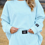 Ice blue waffle long-sleeve top with crew neck and Lulu Mac waist patch