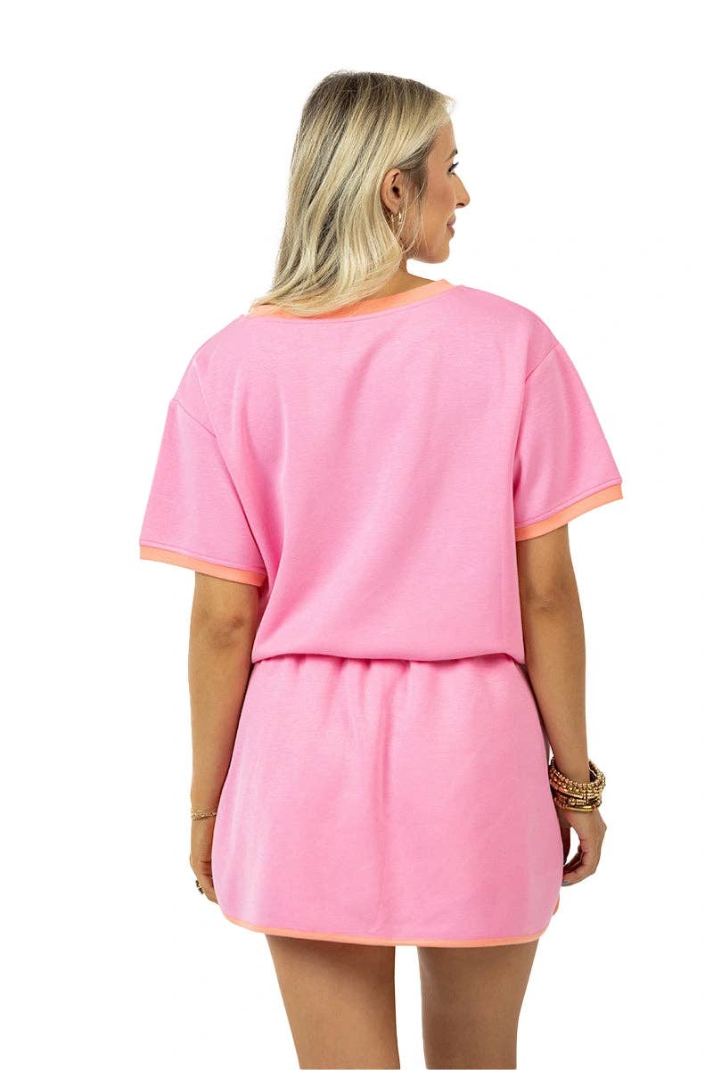 Woman wearing a pink outfit with a plain white background