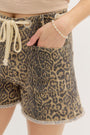 Leopard print shorts with drawstring waist on a plain background