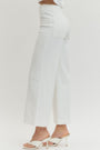 White pants worn by a person on a white background