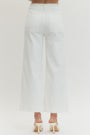 White pants worn by a person on a light gray background