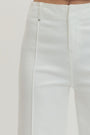 Close-up of white pants on a light gray background