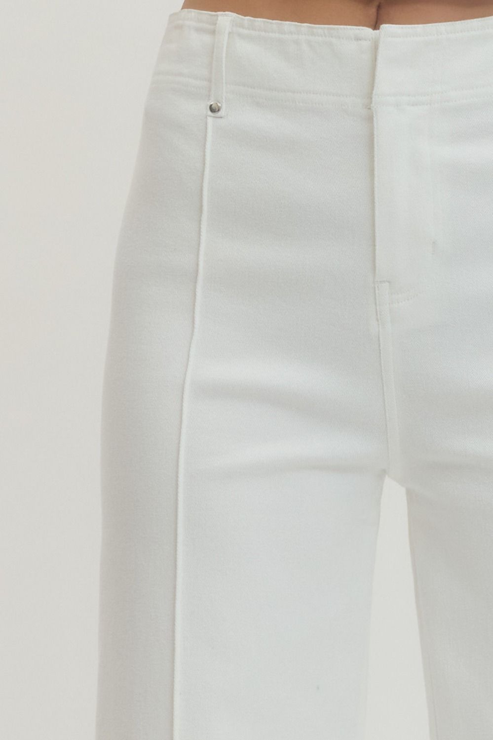 Close-up of white pants on a light gray background