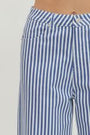 Close-up of blue and white striped pants with a focus on the waistband.