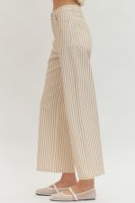 Beige pinstripe pants worn by a person on a white background