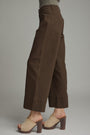 Brown wide-leg pants worn by a person on a plain background